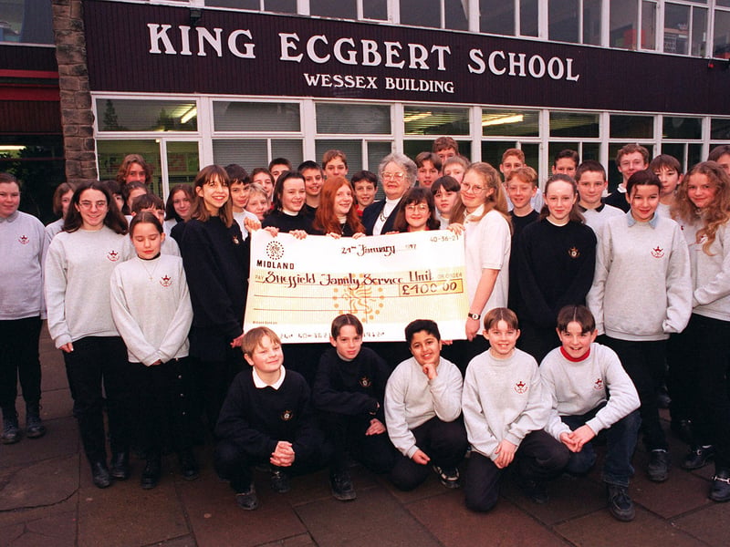 Pupils from King Ecgbert School, Totley, present Mary Sharrock from Sheffield Family Services with a cheque for £400 they raised through their Xmas Cracker activities