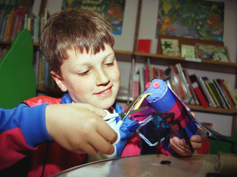 Billy Street-Simmons puts the finishing touches to the millenium bug he made at the Children's Library in 1999