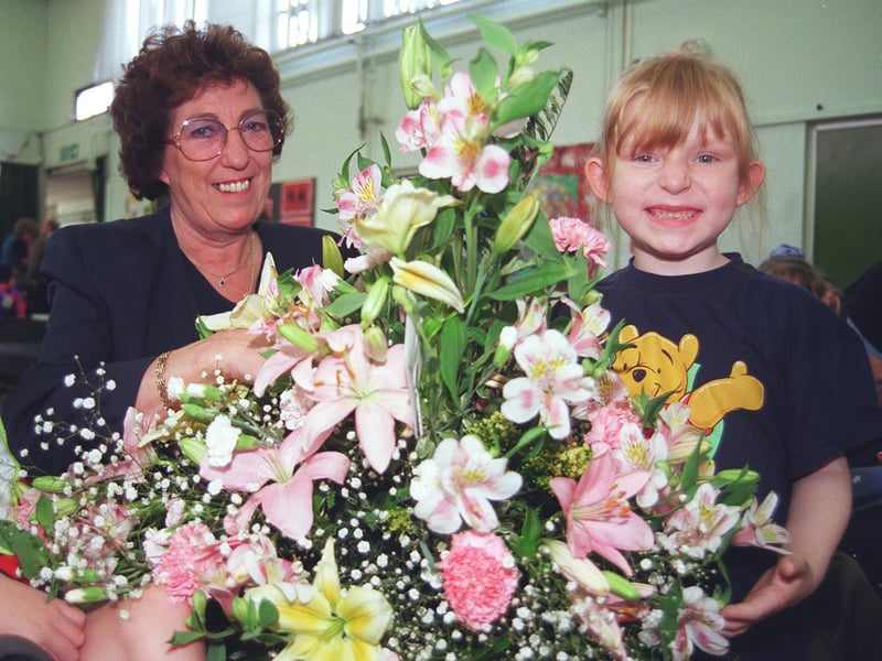 Jenny Woodward is presented with flowers by Laura Gregory (6) as she retires from Norfolk Park Special School after 36 years in 1999