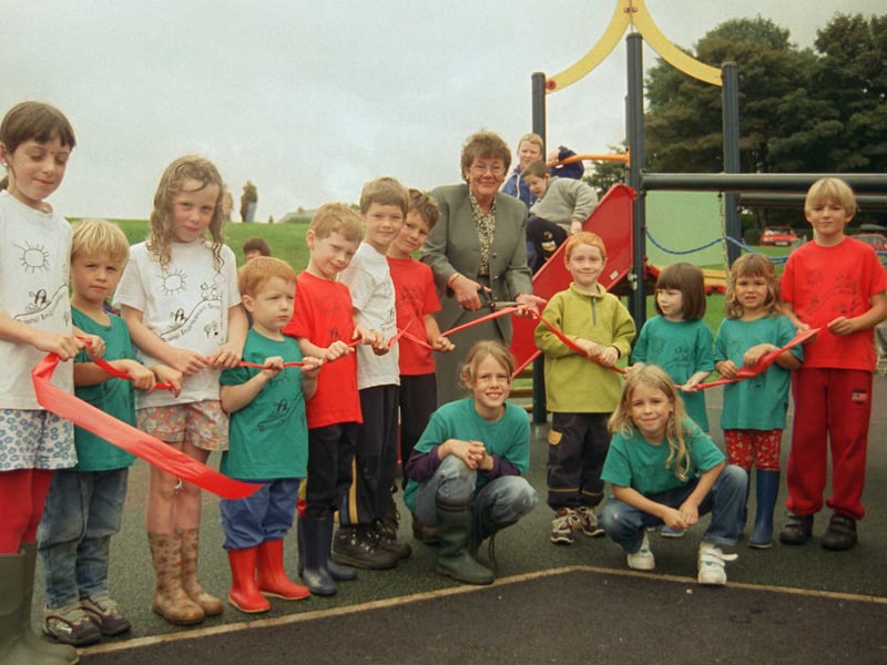 Children celebrate the opening of their new playground at Bold Hill as the ribbon is cut by Norma Haslam in 1999
