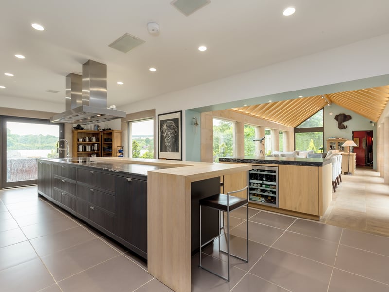 Open plan to the dining room, the kitchen features a five-metre island unit with granite worktop and breakfast bar. Also in the kitchen is a separate island unit for serving the dining area. 