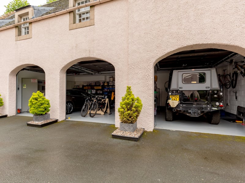 The three-door garage includes a workshop/hub, with a guest flat on the top floor.
