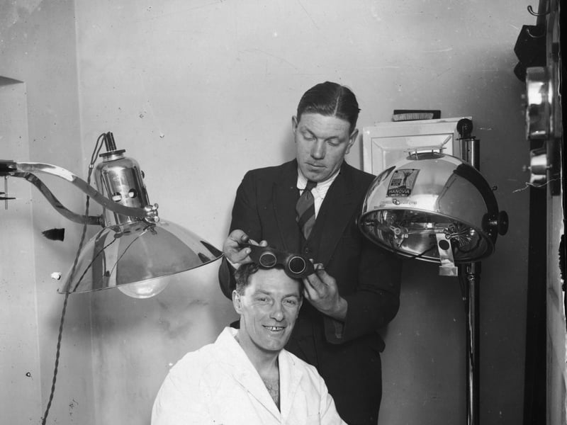 Northampton Town's trainer fits the team captain, W Watson, with some goggles for a course of ultra-violet ray treatment in preparation for an FA Cup tie with Millwall in February 1929