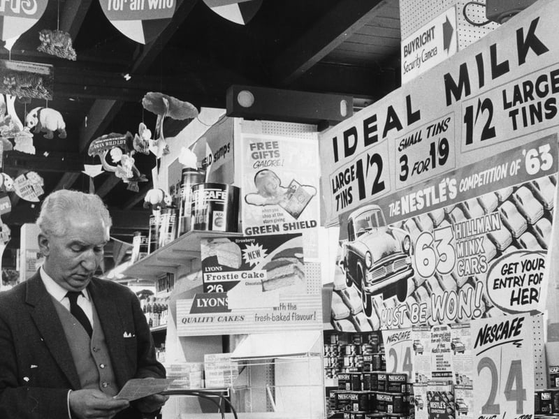 A shopper in a Northampton supermarket consults his shopping list, apparently unaware that he is being watched by a clearly labelled Buyright Security Camera, in April 1963. A CCTV camera monitors the shop's customers, in an attempt to combat shoplifting.
