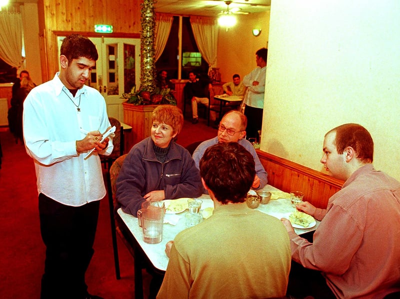 Head waiter Habib Rahman takes customers' orders at the Mangla Indian restaurant and takeaway, Spital Hill, Sheffield, in 1999