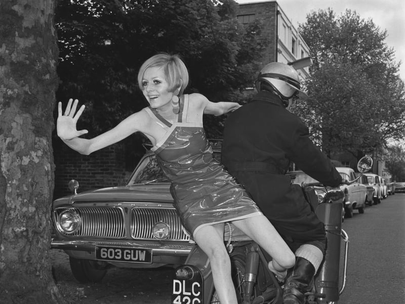 English model Twiggy wearing Bagatel autumn fashions, including this plastic disposable mini-dress, in May 1966