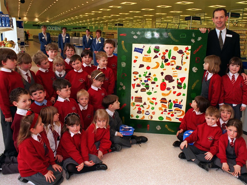 Pupils from Lady Elizabeth Hastings C of E School at Ledston present their prize winning mural to John Hartland, store director of Sainsbury's Savacentre in March 1997.