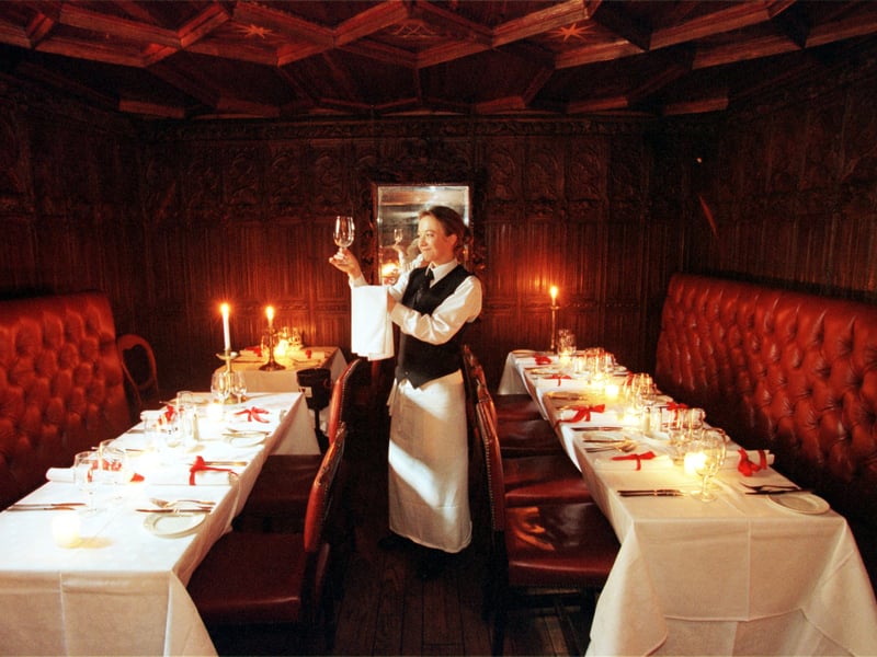 A waiter checks a glass at The Witchery by the Castle restaurant, on the Royal Mile, Edinburgh, in August 1999