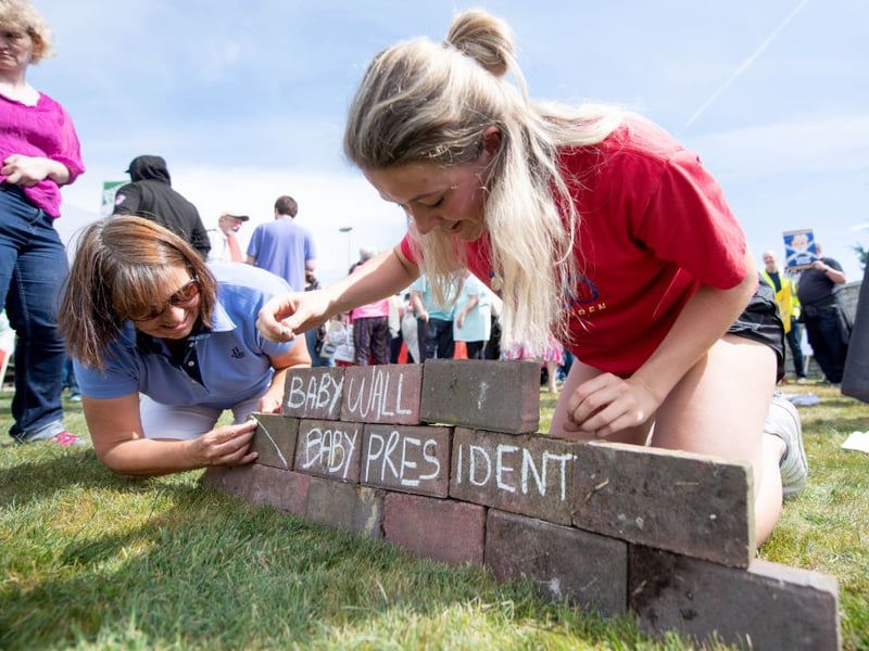 Protestors against the UK visit of US President Donald Trump build a 'baby wall' outside his golf course.