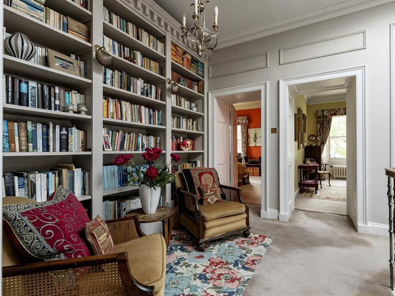 The first-floor landing also includes a reading area with floor to ceiling bookshelves. 