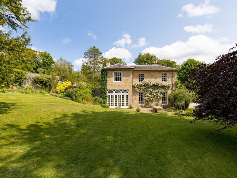 The kitchen leads out to a terrace and the gardens
