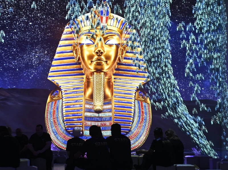 The award-winning experience is spread across 8 expansive rooms with huge 360-degree projections, a virtual reality experience, an interactive metaverse room, two treasure rooms containing artefacts and replicas, a hologram of the mummification process, and an AI photo booth.