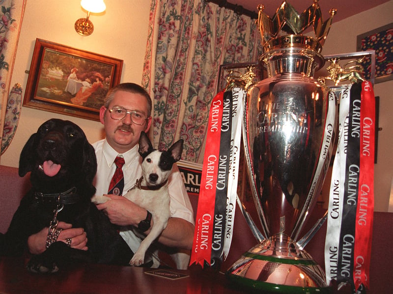 Steve Hawksworth, landlord at the Blacksmiths Arms, Millhouse Green, with his dogs Toby and Tyke (named after Barnsley's mascot) and the FA Carling Premiership Trophy, in 1997