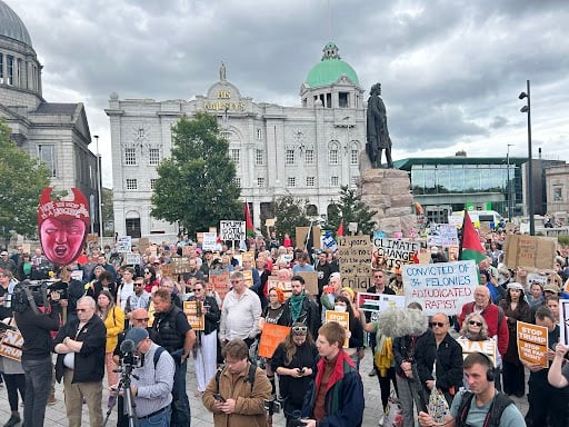 Hundreds of people have already gathered with their placards for today's protest. 