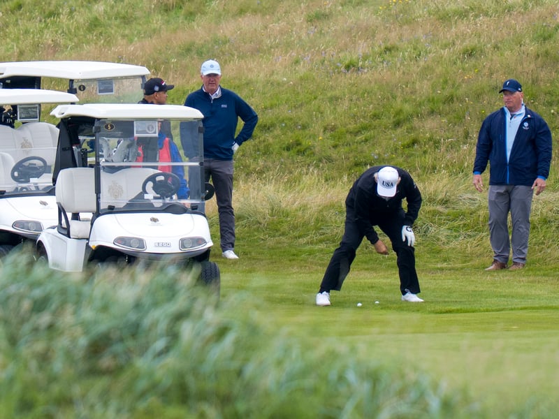 Donald Trump was wearing his white USA cap on the course.