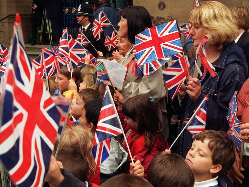 Flag-waving youngsters await the arrival of a Queen Victoria look-alike at Sheffield Town Hall in May 1997, as part of the town hall centenary celebrations
