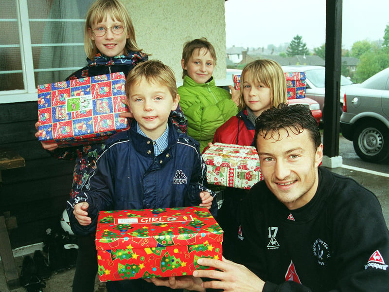 Sheffield United player Petr Katchouro helps launch the Samaritans' annual Christmas shoebox appeal to help needy youngsters in Eastern European contries. Petr is pictured with children from Dobcroft Junior School, Sarah Bailey, William Jackson, Sonia Bailey, and Elin Davies.