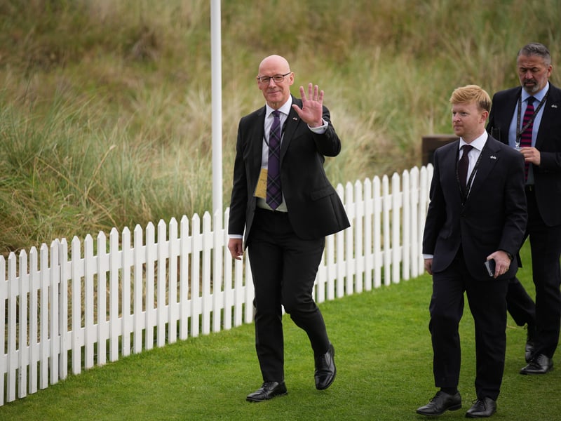 First Minister John Swinney waves as he arrives for a ribbon-cutting ceremony at a new 18-hole course at Trump International Golf Links on in Balmedie.