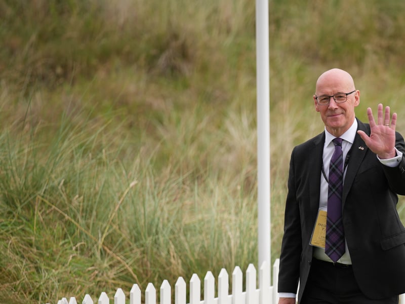 First Minister John Swinney waves as he arrives for a ribbon-cutting ceremony at a new 18-hole course at Trump International Golf Links on in Balmedie.