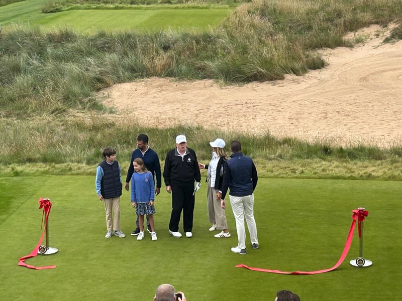 Donald Trump with his son, Donald Jr (left) and family, with Eric Trump (far right), and Lara Trump.
