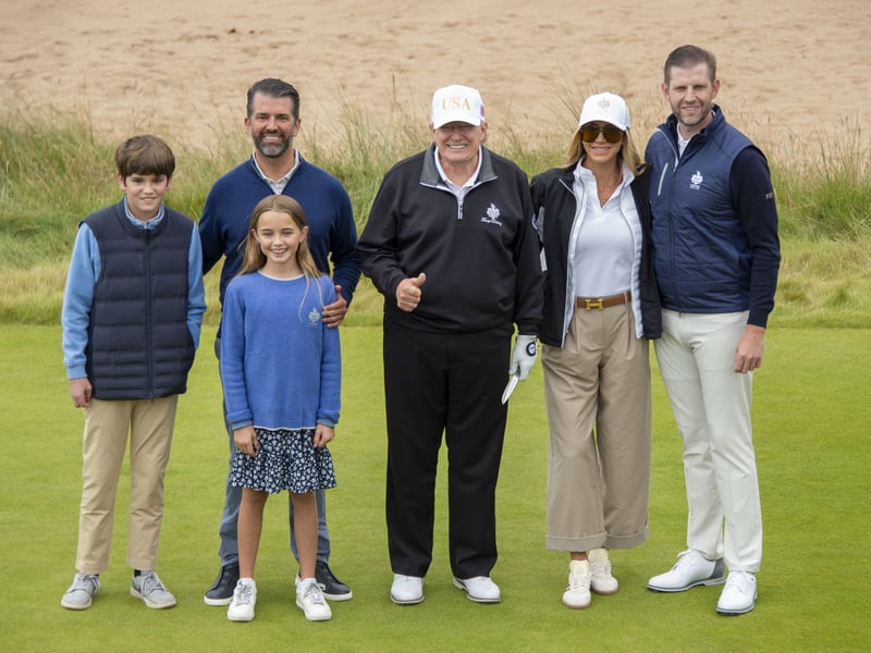 President Trump stands with his family, Donald Jnr with his children Spencer and Chloe and Eric Trump with Lara Trump