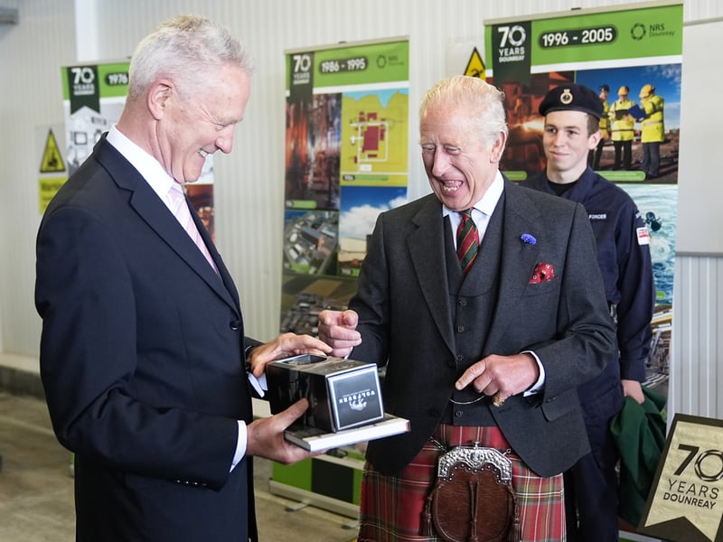 King Charles III, is presented with a book and a bottle of whisky during a reception for Caithness Communities hosted by the Nuclear Decommissioning Authority at Scrabster Harbour in Thurso, Scotland.