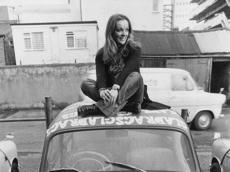 Yvonne Freeman sits atop her garishly painted Skoda, bearing the slogan 'Look Good', in 1971