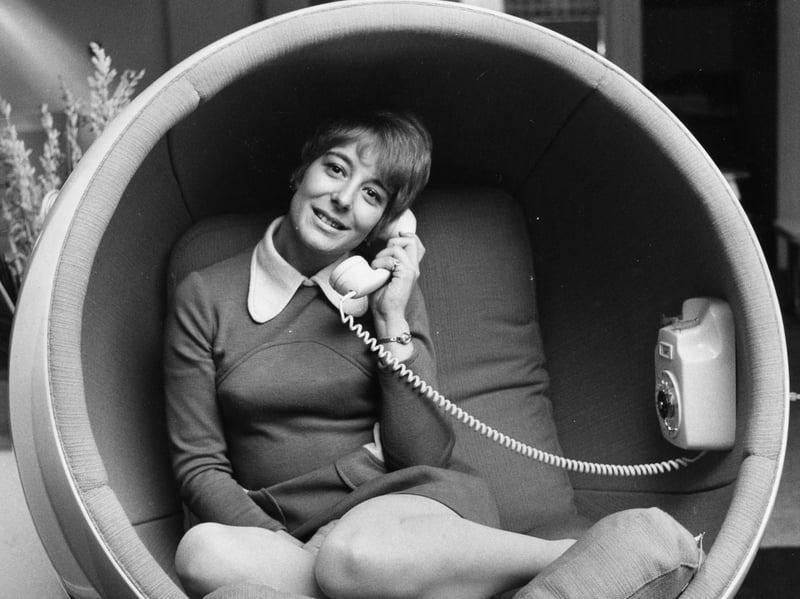 Julie Philpott sits comfortably in the Asco Bomb Chair, with a built-in telephone, on display at the 'Into The 70s' exhibition designed by Homes And Gardens in March 1970