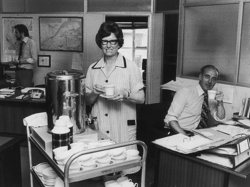 Tea lady Alice Bond provides refreshments for office workers in July 1976