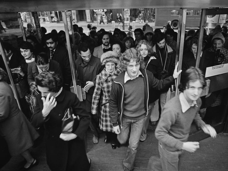 Customers rush through the doors at a Debenhams department store as the post-Christmas sale begins in December 1975