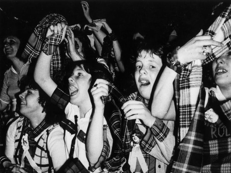 Ecstatic tartan-clad Bay City Roller fans at a concert in May 1975