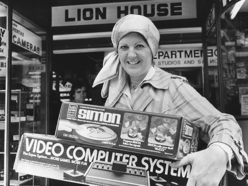 A shopper carries boxes of computer toys and games in June 1979, after a rush to buy was brought on by the expected rise in VAT in the Budget