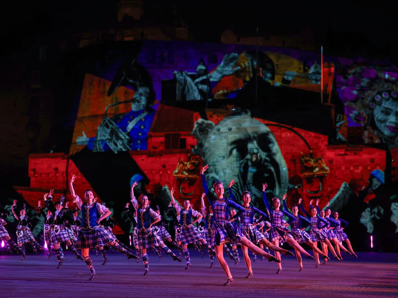 Dancers perform in front of playful projections lighting up the Castle