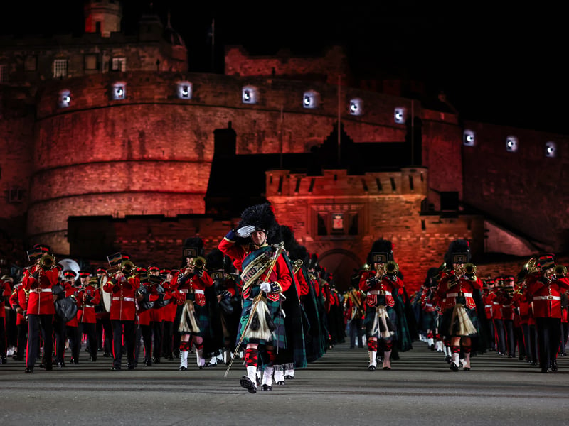 Performers march off the castle esplanade following the finale of the 75th Royal Military Tattoo 