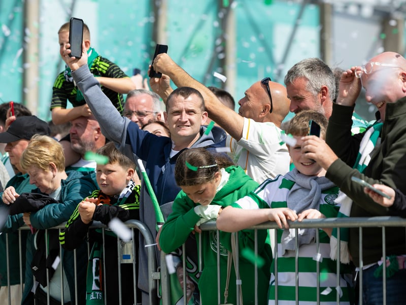 Celtic fans take photos of the team as they arrive for the opening game vs St Mirren.