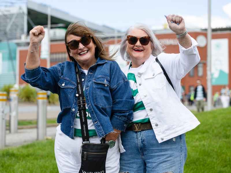 Two fans get ready to celebrate Flag Day at Celtic Park.