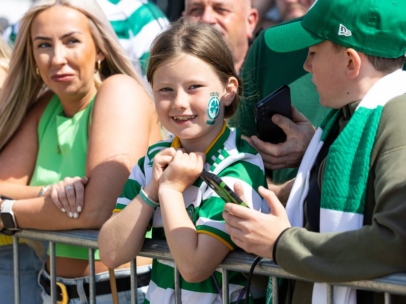 A young fan awaits her heroes after having the Celtic badge face painted on her cheek.