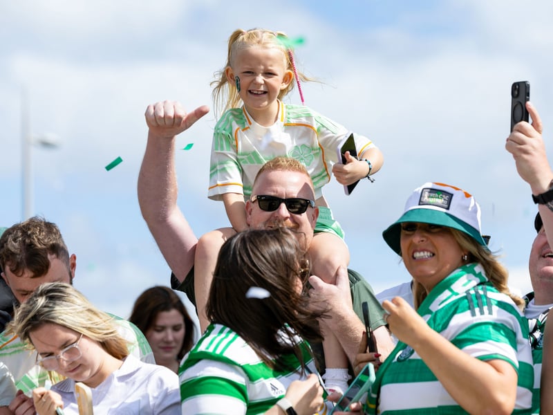 Celtic fans give the camera the thumbs up ahead of the player's arriving on Celtic Way.