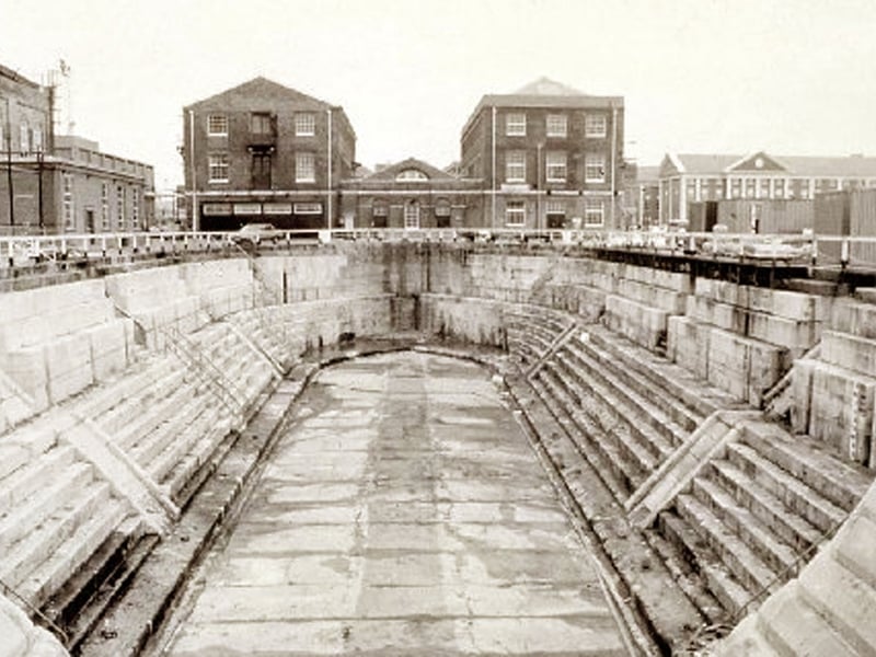 Docks 5 and 6 are part of a complex of late 18th century and early 19th century ship building and repairing docks with associated quay walls and mooring fixtures. Dock 6 is suffering from rotation, open mortar joints, water penetration through mitre gate and spalling stonework. Dock 5 has been flooded due to failure of the gates and is vulnerable to algal growth and saturation of stonework with risk of accelerated decay. Works to address water ingress at Dock 6 have been granted SMC and are due to be undertaken soon. This will allow for future conservation repair work to the dock and mitre gate. It has been given a priority C Grade, and is suffering from “slow decay". It is described as being in a poor condition and is a Scheduled Monument.