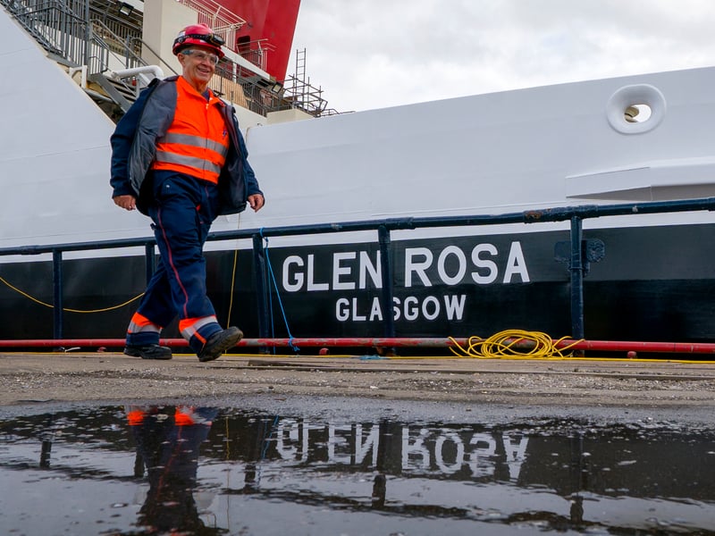 Fabrication quality inspector David Watt alongside the Glen Rosa during an inspection at Dales Marine, Greenock. The ferry has been in dry dock to complete the next important steps in the building process, with the hull getting its fresh coat of paint and the propellers and drive shaft being polished to a high shine. Picture: Jane Barlow/PA Wire 