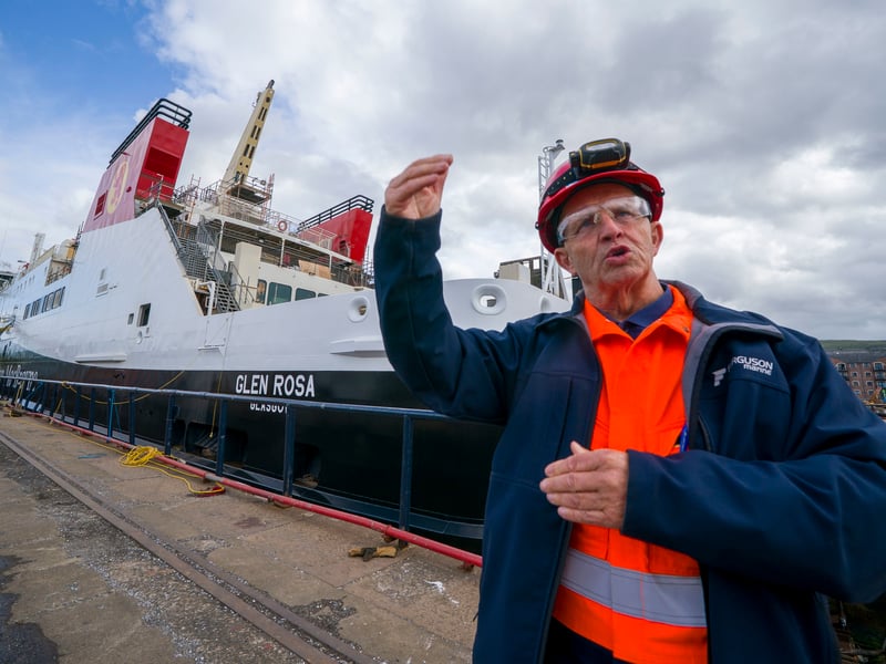 Fabrication quality inspector David Watt speaks about the Glen Rosa, which sits in the background. Picture: Jane Barlow/PA Wire