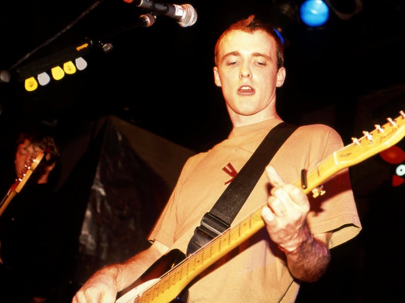 Formed in Glasgow in 1990, Travis emerged in the mid-90s with their brand of gentle, melodic Britpop. Their breakthrough album, The Man Who (1999), catapulted them to global stardom with hit singles like 'Why Does It Always Rain on Me?' They were a pivotal band in the transition from Britpop to a more reflective, acoustic-led style of rock, paving the way for many of the bands that would dominate the 2000s.