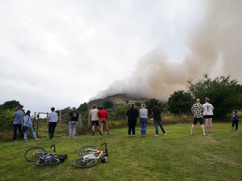 Members of the public were photographed watching the large clouds of smoke from the fire on Arthur's Seat in Holyrood Park, Edinburgh.