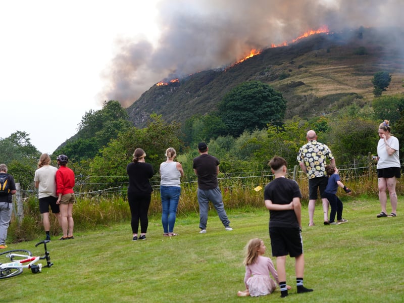 Members of the public stand back and watch flames rip through Arthur's Seat.