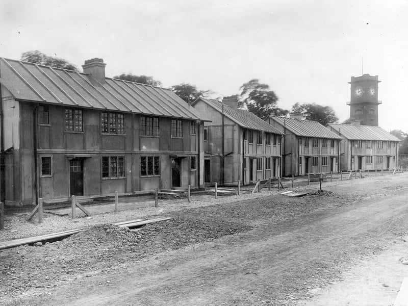 Pre-fabricated houses on York Road, part of the Cross Gates estate. The houses run from no. 614 on the left to 600 on the right. The clock tower of Seacroft Hospital is seen in background. Pictured in June 1921.