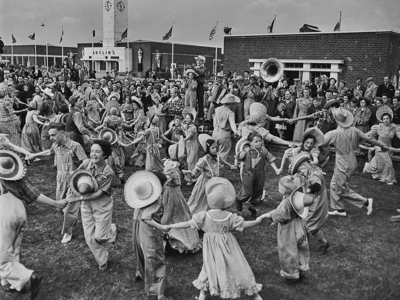 Children square dancing with the band playing in the background, at Butlin's holiday camp in Filey, North Yorkshire, in July 1952