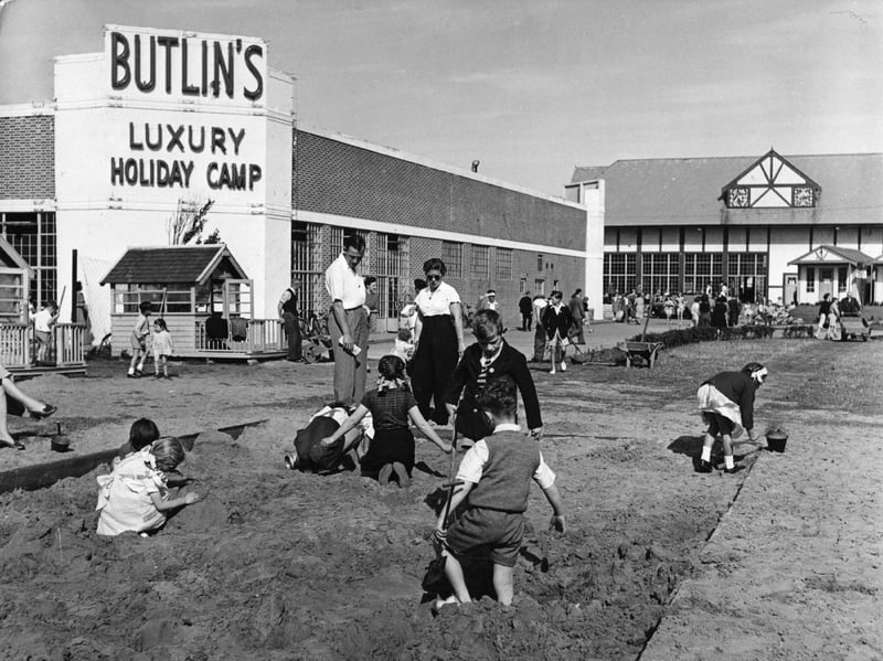 Children playing in the sandpit at a Butlin's holiday camp in around 1955