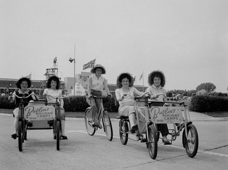 A group of women in straw hats riding quadracycles at Butlins Holiday Camp, Clacton-on-Sea, Essex, in August 1956