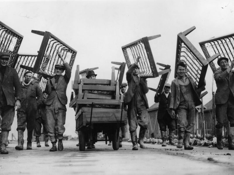 Workmen carrying bedsteads to the chalets at Butlin's holiday camp, Skegness, in March 1937