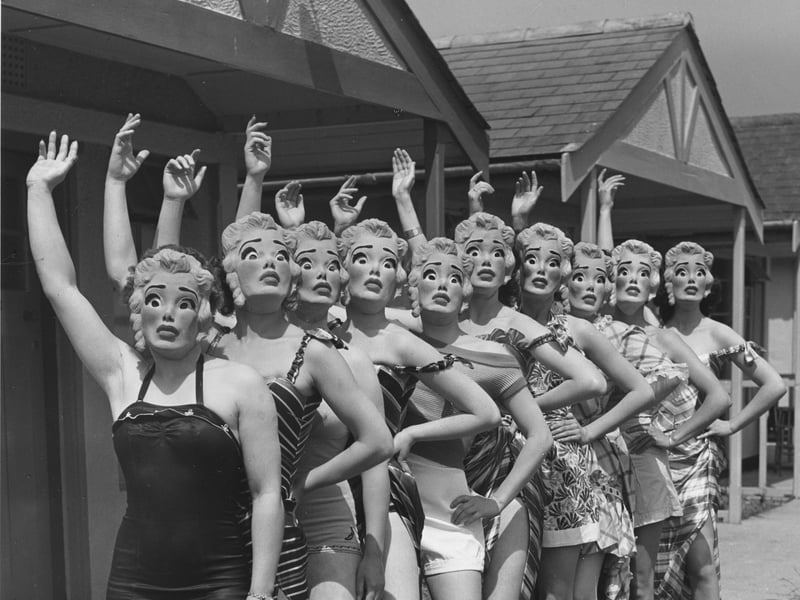 Workers at Butlin's holiday camp wearing Marilyn Monroe face masks as they parade in their swimsuits in May 1952. Masks were introduced so beauty contestants could be judged 'solely on their figures'.